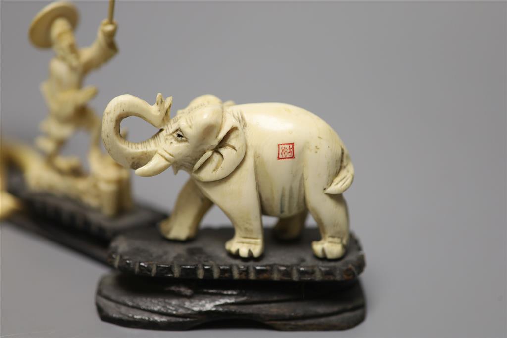 A Japanese carved ivory figure, male with brush, Meiji period, an elephant, a fisherman and a bangle